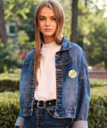 Person wearing denim jacket with a badge, protected by Clear Badge Film For Button Making 400 Pcs Protective PVC Shield.