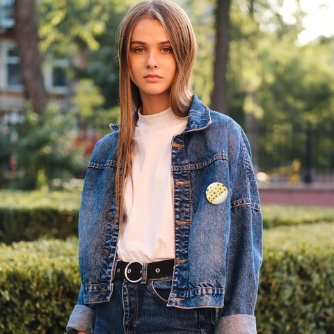 Person wearing denim jacket with a badge, protected by Clear Badge Film For Button Making 400 Pcs Protective PVC Shield.