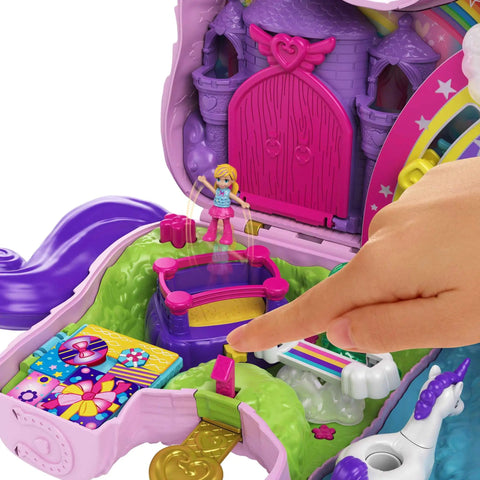 Close-up of Unicorn Party Playset With 25 Surprises, pink unicorn toy, showing a finger pointing to the castle adventure section.