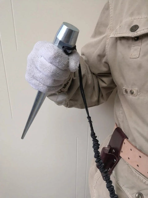 Person holding Beefed-Up Heavy Duty Broad Head Bull Pin Alignment Punches Cone From 1-1/4 In To 5/16 In 13.75 In Long Heat Treated