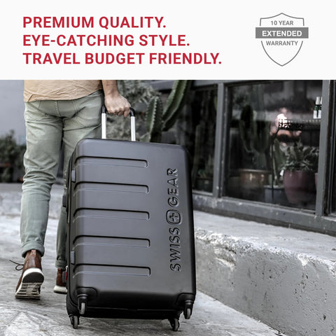 SwissGear 7366 black hardside carry-on luggage with spinner wheels, 19-inch, being pulled by a person