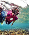 Two snorkelers underwater using Spectra Dry Snorkel With Purge Valve And Quick Connect Clip, black and pink gear visible.