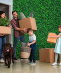 Family in room with Artificial Boxwood Roll Panels 48x120 Inches Cover 40 Sq Ft UV Resistant Faux Ivy Leaves Privacy Fence