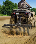 Heavy Duty ATV UTV Landscape Rake Attachment for yard cleanup and land grading in use, leveling soil with adjustable width