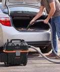 Heavy Duty 4 Gallon Wet Dry Shop Vacuum With 5.5 Peak HP Blower Function being used to clean car debris from trunk.