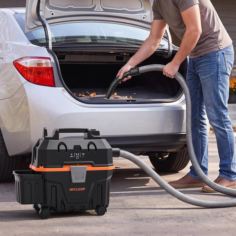 Heavy Duty 4 Gallon Wet Dry Shop Vacuum With 5.5 Peak HP Blower Function being used to clean car debris from trunk.