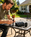 Heavy Duty Black Vinyl End Caps Assortment Kit With 40 Pieces For Multiple Sizes Including Quarter And Half Inch To Protect Furniture Legs And Metal Threads From Scratches While Keeping Your Home Projects Looking Fresh. Man fitting black vinyl end cap on metal table leg outdoors