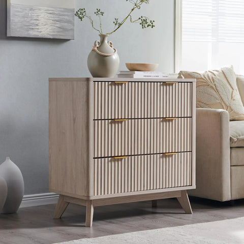Set Of Two Fluted Nightstands Featuring Three Spacious Drawers And Clean White Alder Finish in stylish beige setting with decor.