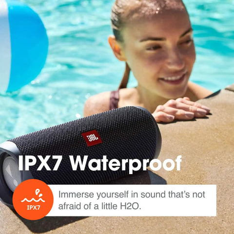 Flip 5 Bluetooth Speaker Bundle With Divvi Protective Hardshell Case shown poolside in black, demonstrating waterproof capability.