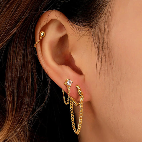 Four Pair Chain Earrings For Women With CZ Ball Studs, Dangling Front To Back Bar Huggie Hoops, Gold Tone Set, Copper Chain Drops, 3cm Length, Stainless Steel Posts, Comfortable Everyday Sparkle. Gold-tone CZ chain earrings on ear