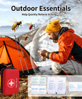 Front view of red compact waterproof hard-case first aid kit with white cross, outdoors near camping tent