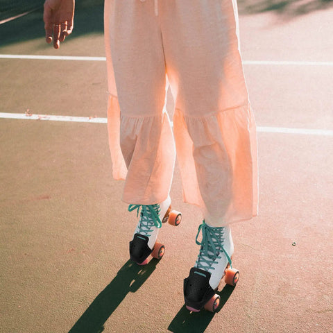 Person skating on outdoor court with black Two Pack Roller Skate Toe Cap Guards Protectors PU Leather Toe Covers for Quad Skates.