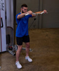 Man using Straight Up Heavy Duty Aluminum Curl Bar Attachment Compatible With Cable Machines for arm workouts in home gym.