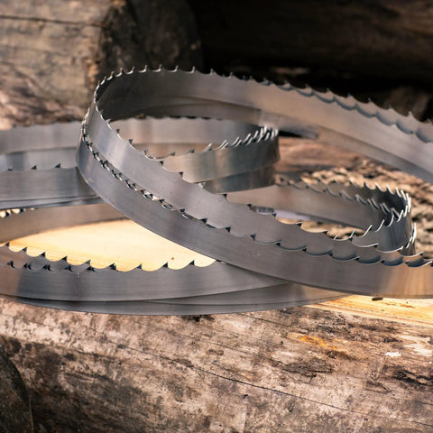 5 Pack 144 Inch Sawmill Blades DoubleHard 10 Degree All Purpose Hook Angle For Portable Sawmills High Alloy Steel Delivers Twice The Sharp Life Compatible With Popular Portable Sawmill Brands And Models showcased on wooden logs