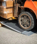 Heavy Duty Aluminum Shipping Container Forklift Ramp 60 By 63 Inch Deck Designed For 12000 Lb Per Axle Loads with forklift in use.