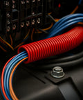 3/4 Inch Split Wire Loom Tubing 10 Foot Polyethylene Corrugated Flexible Conduit protecting blue and orange wires in an electrical setup.