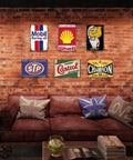 Kickass Vintage Metal Tin Signs Set Of Six Retro Garage Wall Decor Featuring Distressed Oil And Gas Station Prints For Awesome Man Cave Badass Automotive Wall Art displayed in a cozy brick-walled room.