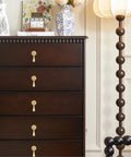 Dark wood dresser with Solid Brass Cabinet Knobs 2 Pack in Brushed Gold Finish installed, showing modern pendant pulls for cabinets and drawers.