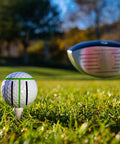Golf ball on tee with alignment marks, part of 8 Pack Precision Golf Ball Marker Set With 4 Color Marking Stencils And 4 Vibrant Markers