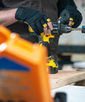 Person using Four And One Eighth Inch Tungsten Carbide Tipped Hole Saw Non Arbored for drilling in wood, visible accessories.