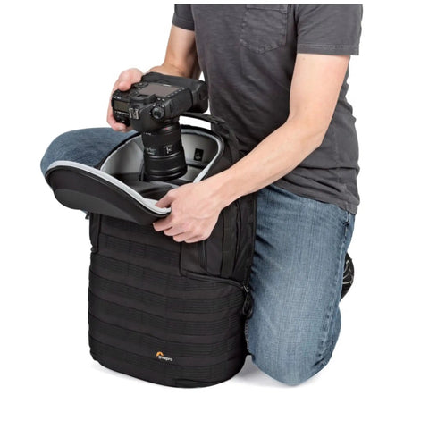 Person placing camera in ProTactic BP 450 AW 2 25L Modular Camera Backpack With CradleFit Pocket All Weather Cover SlipLock Compatible.