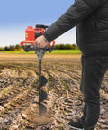 Person using Gas Powered Post Hole Digger With 2.3HP Engine Earth Auger Kit With 3 Drill Bits And 11.81 Inch Extension Rod in a field