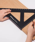 Hands using Pro Grade 12 Inch Carpenters Square CNC Aluminum Right Angle Layout and Marking Tool on wooden board