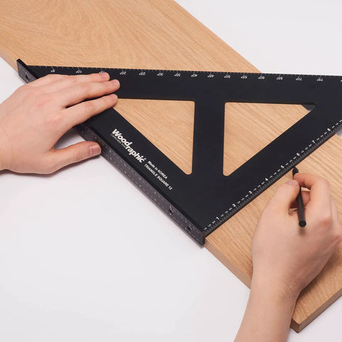 Hands using Pro Grade 12 Inch Carpenters Square CNC Aluminum Right Angle Layout and Marking Tool on wooden board