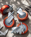 Set Of 4 Transmission Jack Casters 1/2 Inch-13 Red Poly Rotating Threaded Rod Casters With 360 Degree Swivel Wheels, tools nearby