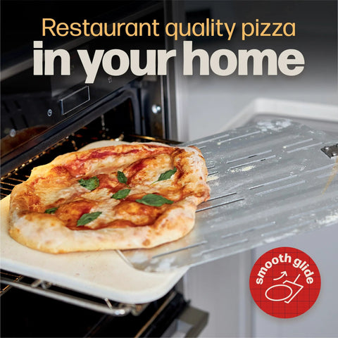 Side view of perforated metal pizza peel with pizza, inserted into an oven; Smooth Glide badge visible.