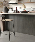 Grey Peel And Stick Wood Wall Panels 3D PVC Wood Slat Wallpaper Renter Friendly showcased in modern kitchen with bar stool.