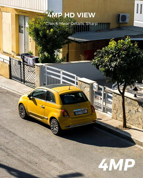 Aerial view of a yellow car parked on a residential street beside a house with a fence and trees, showcasing 4MP HD image quality.