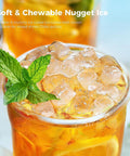 Close-up of soft chewable nugget ice in a glass, ideal for drinks, from the Countertop Nugget Ice Maker Delivers 34 Pounds Daily With One Touch Control And Self Clean Wash For No Sweat Party Hosting And Home Kitchens Office Lounges Or Road Trip Adventures.