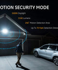 Motion Sensor Outdoor Flood Light With 3 Head LED Security Light illuminating driveway at night, car parked, person walking