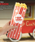 Person holding a Large 2 Oz Red And White Paper Popcorn Bag Bulk 100 Pack Disposable Grease Resistant Bags for carnival party vibes.