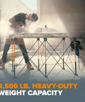 Person using Portable Folding Work Table Kit For Diy And Shop Use A Sturdy 24 By 48 Inch Work Surface With 1500 Lb Capacity And A 30 Inch Working Height Complete Accessories Pack Including Six X Cups Non Slips Three Quick Clamps Two Cord Hooks And Carry Bag CK625 in workshop