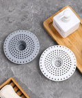 Universal Five Inch Silicone Shower Drain Hair Catcher in grey and white, essential tools for preventing clogs.