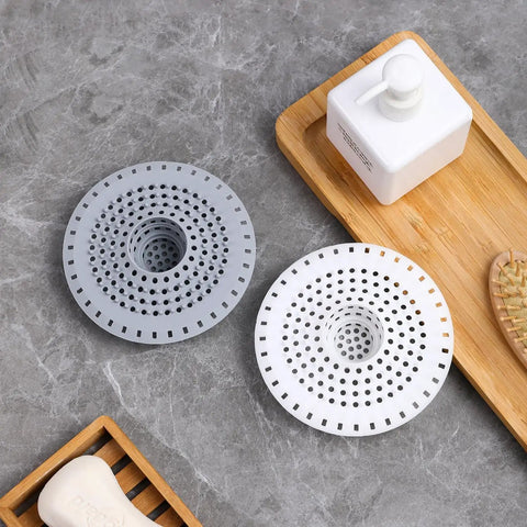 Universal Five Inch Silicone Shower Drain Hair Catcher in grey and white, essential tools for preventing clogs.