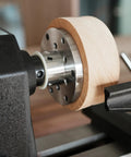 Close-up of Heavy Duty 1x8Tpi Face Plate Kit For Woodturning Lathes including wooden bowl on lathe with steel plate.
