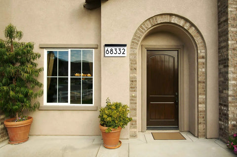 House facade with Solar Powered Address Plaque With LED Illumination, Waterproof Outdoor House Number Sign beside the door.