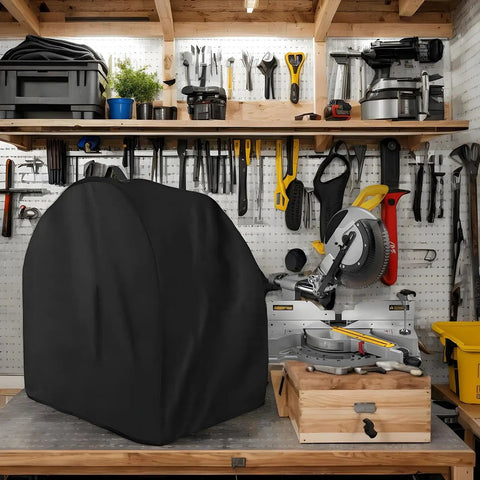 Heavy Duty Miter Saw Cover Waterproof Dust Shield protecting miter saw in garage with tools on shelves above.
