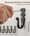 Heavy Duty Kickass Cast Iron Wall Hooks 5 Pack Handmade Blacksmith J Hooks installed with screwdriver and mounting hardware.