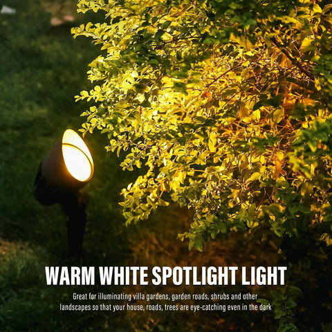 4 Pack Low Voltage Outdoor Landscape Flood Lights 5W LED Kit illuminating garden bush at night, 12V, 2700K warm white.