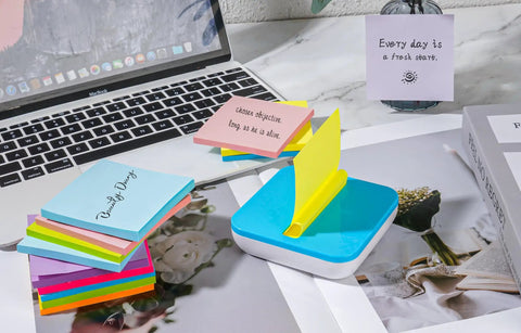 Burst Of Color Sticky Notes Refills 3x3 Pop Up Pads With 9 Bright Colors shown in dispenser on desk next to laptop