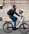 Woman riding High Power 1200W Electric Bike For Adults With 26 Inch Wheel 528Wh Removable Battery 28 MPH Top Speed 62 Mile Range Step Through Commuter Ebike For Men And Women UL2849 Certified, showing compatibility with pannier bags, rear basket, and front basket.