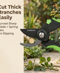 Close-up of bypass garden shear cutting branch, showing curved sharp blade and spring jaw against garden backdrop.