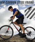 Person riding Trail Ready 27.5 Inch Mountain Bike For Men And Women, 21 Speed Shifting, Dual Disc Brakes, Suspension Fork, High Carbon Steel Frame, All Terrain MTB For Gravel Dirt And Rocks, Black on rocky trail.