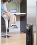 Room with a T500 Tower Air Purifier and a child sitting in the background, featuring a Replacement Air Filter For T500 Tower Air Purifier, True HEPA Filter That Captures 99.99 Percent Of Particles Down To 0.1 Micron, Zaps Mold Bacteria Odors Allergens Pollen Dust Dander And Pet Fur For Cleaner Air.