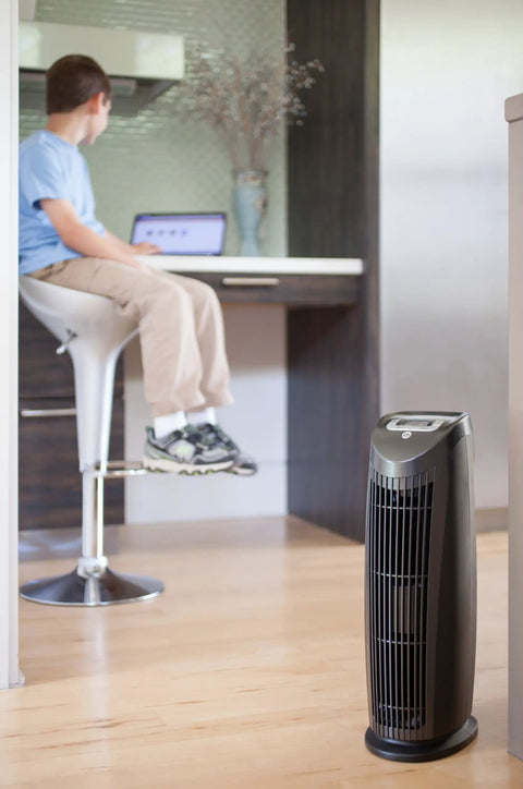 Room with a T500 Tower Air Purifier and a child sitting in the background, featuring a Replacement Air Filter For T500 Tower Air Purifier, True HEPA Filter That Captures 99.99 Percent Of Particles Down To 0.1 Micron, Zaps Mold Bacteria Odors Allergens Pollen Dust Dander And Pet Fur For Cleaner Air.
