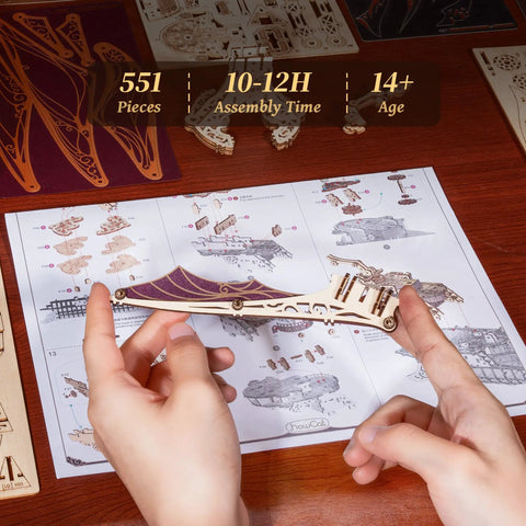 Hands assembling 3D Wooden Pirate Ship Puzzle Kit With Purple Hull, a victorian steampunk galleon craft for ages 14+, 518 pieces.